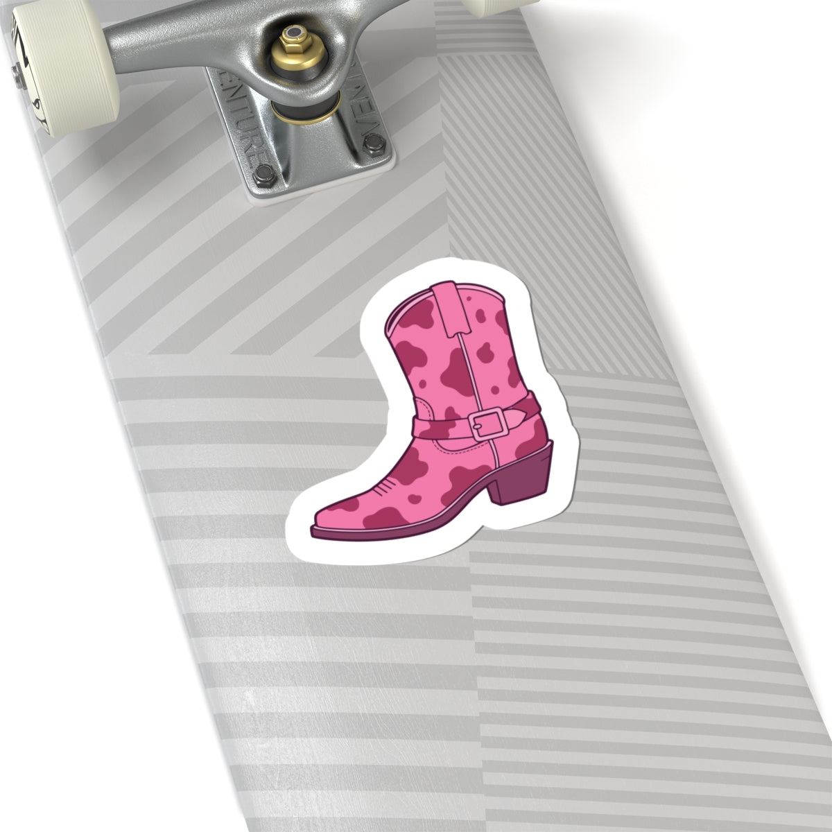 Pink cowgirl boot sticker on a skateboard deck